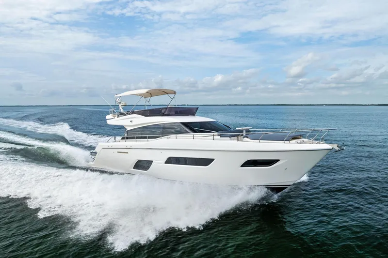 Slide: The Image of 2018 Ferretti Yachts 550 cruising on open water under a clear sky. - 20