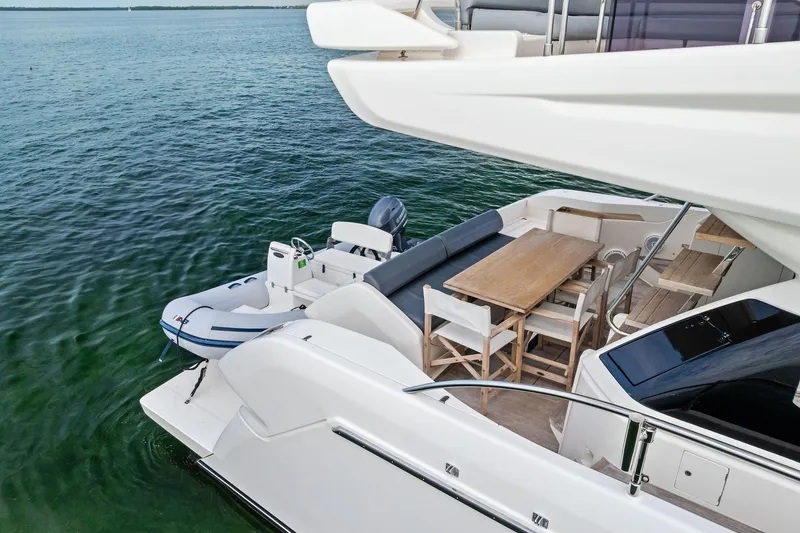 Slide: The Image of 2018 Ferretti Yachts 550 with outdoor dining area and tender on calm water. - 25