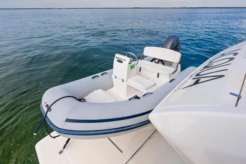 Slide: The Image of 2018 Ferretti Yachts 550 with inflatable tender on calm ocean waters. - 29