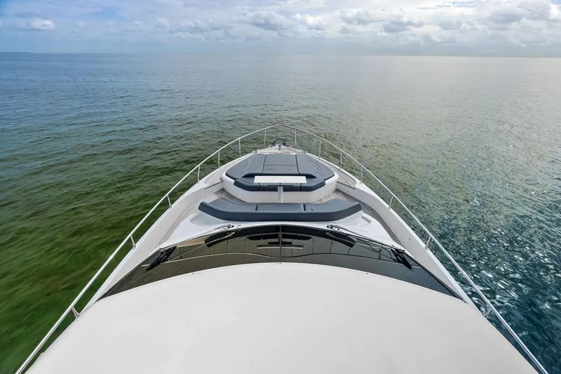 Slide: The Image of 2018 Ferretti Yachts 550 cruising on calm ocean waters under a cloudy sky. - 42