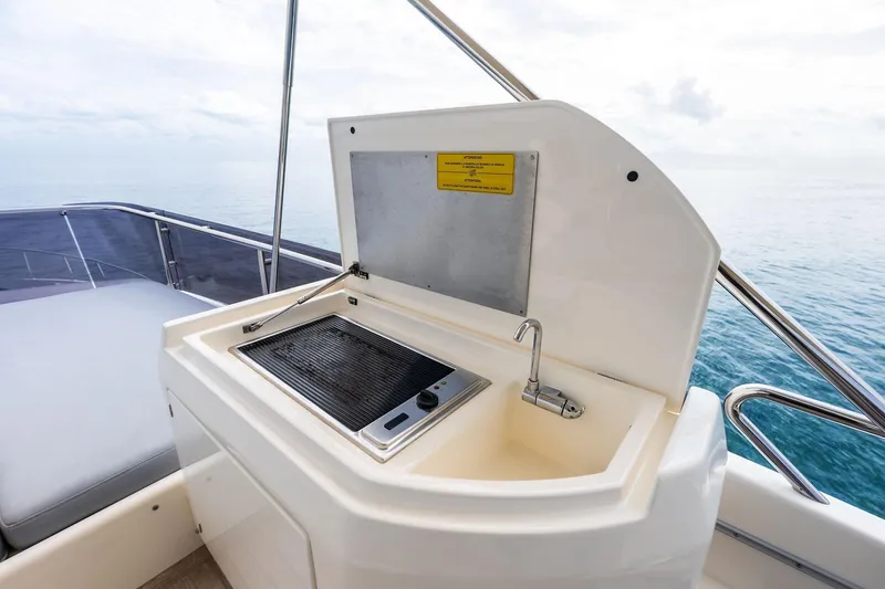 Slide: The Image of Outdoor kitchenette on 2018 Ferretti Yachts 550, featuring a grill and sink. - 52