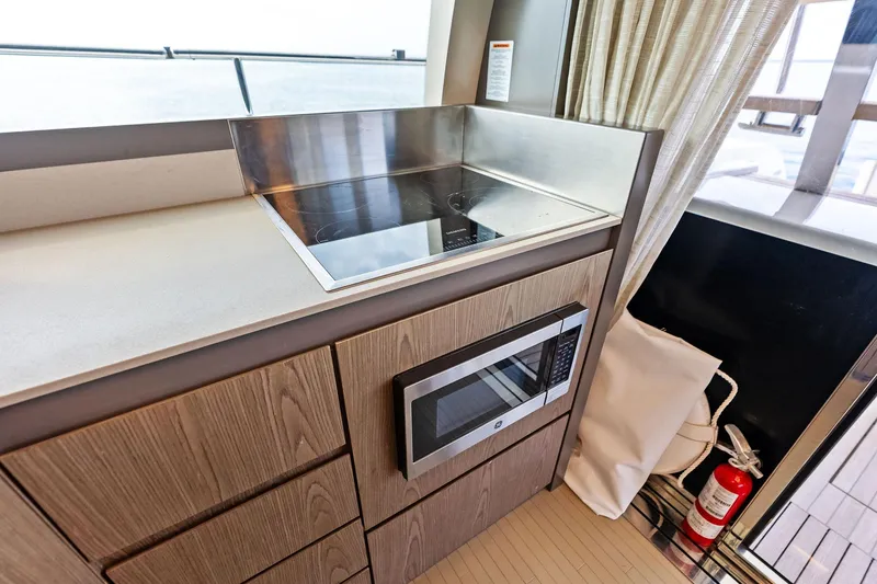 Slide: The Image of Modern kitchen area on 2018 Ferretti Yachts 550 with stove and microwave. - 62