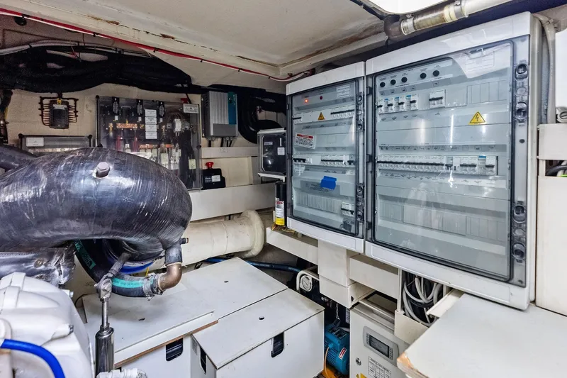 Slide: The Image of Engine room of 2018 Ferretti Yachts 550, showcasing electrical panels and machinery. - 94