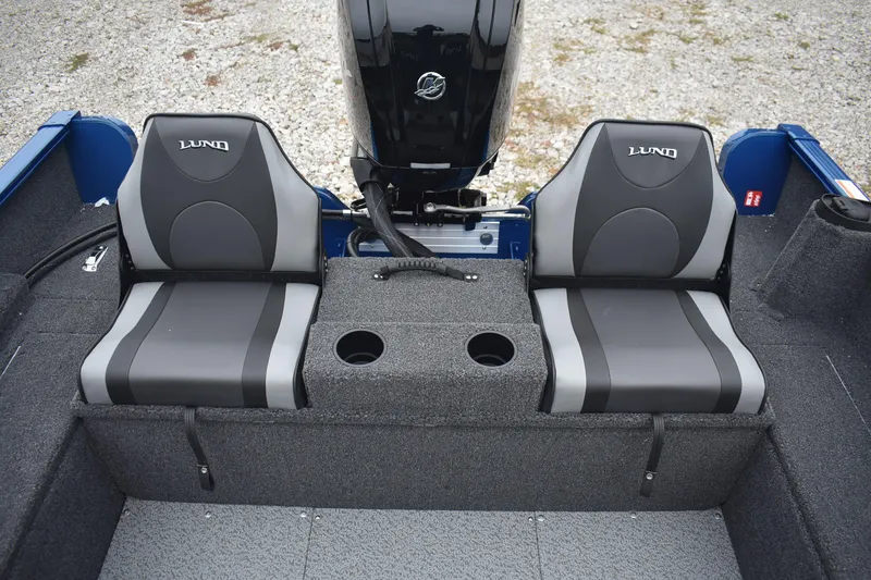 Slide: The Image of 2026 Lund 1650 Rebel XL Sport boat seats with center console and cup holders. - 15