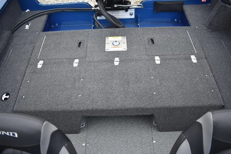 Slide: The Image of 2026 Lund 1650 Rebel XL Sport boat interior with storage compartments and seating. - 16