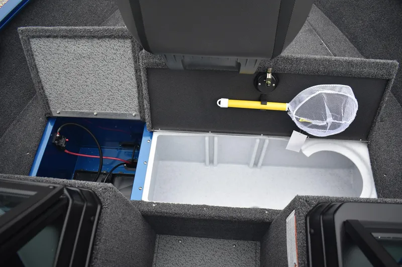 Slide: The Image of 2026 Lund 1650 Rebel XL Sport boat interior with storage compartments and fishing net. - 17