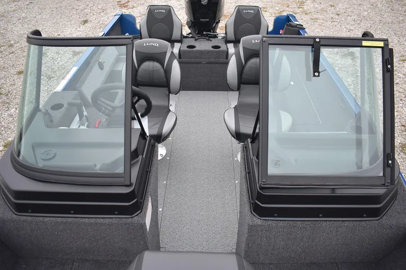 Slide: The Image of 2026 Lund 1650 Rebel XL Sport boat interior with dual consoles and seating. - 18