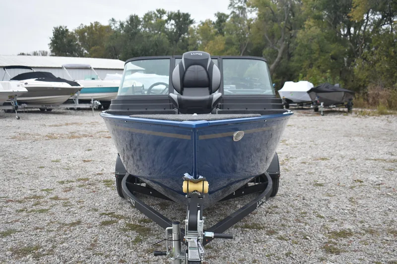 Slide: The Image of 2026 Lund 1650 Rebel XL Sport boat on trailer, parked outdoors. - 3