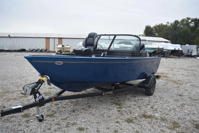 Slide: The Image of 2026 Lund 1650 Rebel XL Sport boat on trailer, parked outdoors. - 4