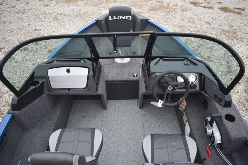 Slide: The Image of 2026 Lund 1650 Rebel XL Sport boat interior with steering console and seating. - 8