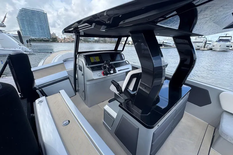 Slide: The Image of 2025 Wajer 38s boat interior with table, overlooking waterfront cityscape. - 18