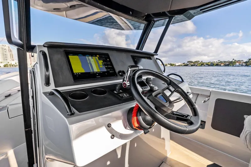 Slide: The Image of 2025 Wajer 38s boat cockpit with modern steering and navigation display. - 24