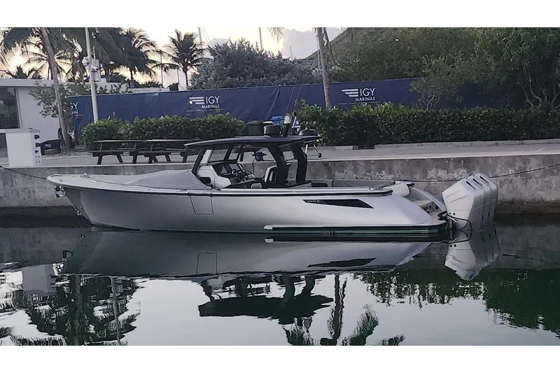 Slide: The Image of 2025 Wajer 38s luxury boat on calm water with scenic palm tree backdrop. - 5