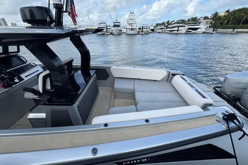 Slide: The Image of 2025 Wajer 38s luxury boat on calm water with scenic shoreline background. - 7