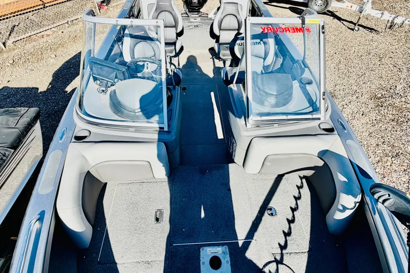 Slide: The Image of 2017 Crestliner 1850 SPORT FISH boat interior with seating and windshield, parked outdoors. - 16
