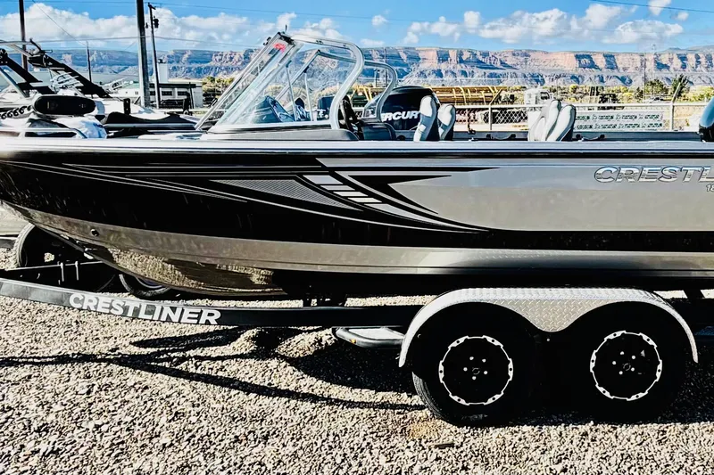 Slide: The Image of 2017 Crestliner 1850 Sport Fish boat on trailer, scenic mountain backdrop. - 5