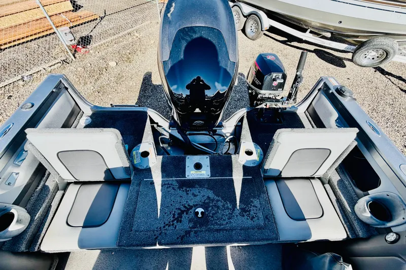 Slide: The Image of 2017 Crestliner 1850 Sport Fish boat interior with seating and motor, parked on gravel. - 9