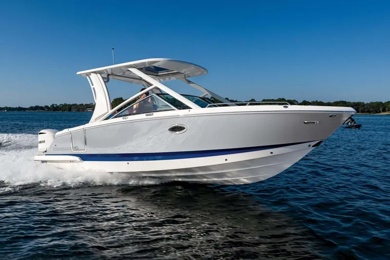 Slide: The Image of 2024 Chaparral 280 OSX boat on trailer, surrounded by palm trees under a clear sky. - 1