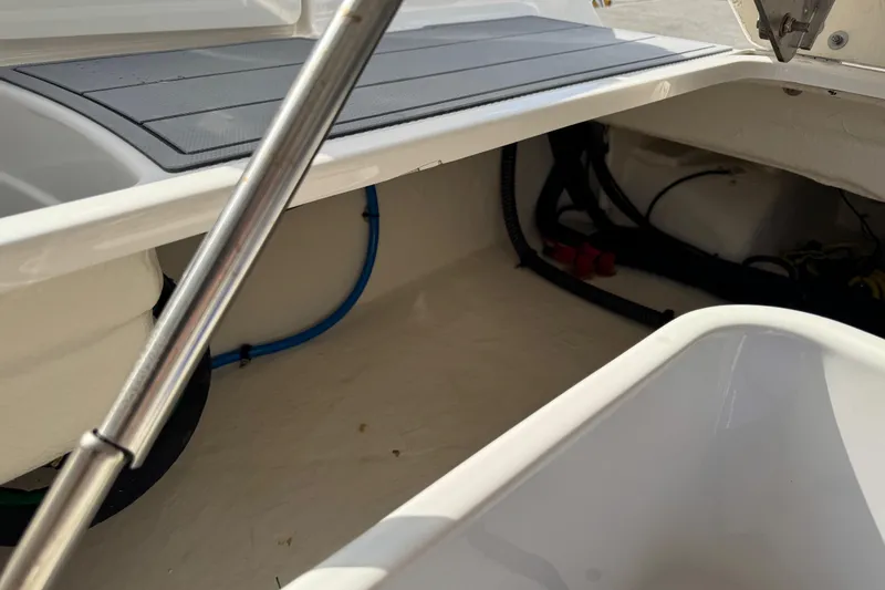 Slide: The Image of 2024 Chaparral 280 OSX boat storage compartment with hydraulic support and wiring. - 100