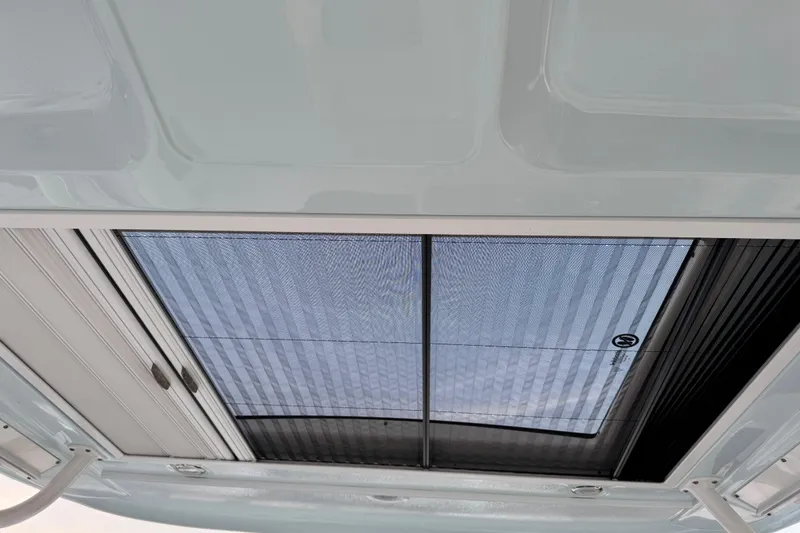 Slide: The Image of 2024 Chaparral 280 OSX boat sunroof with retractable shade, interior view. - 103
