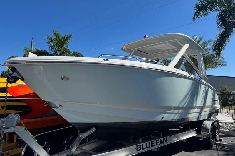 Slide: The Image of 2024 Chaparral 280 OSX boat logo on sleek white surface. - 20