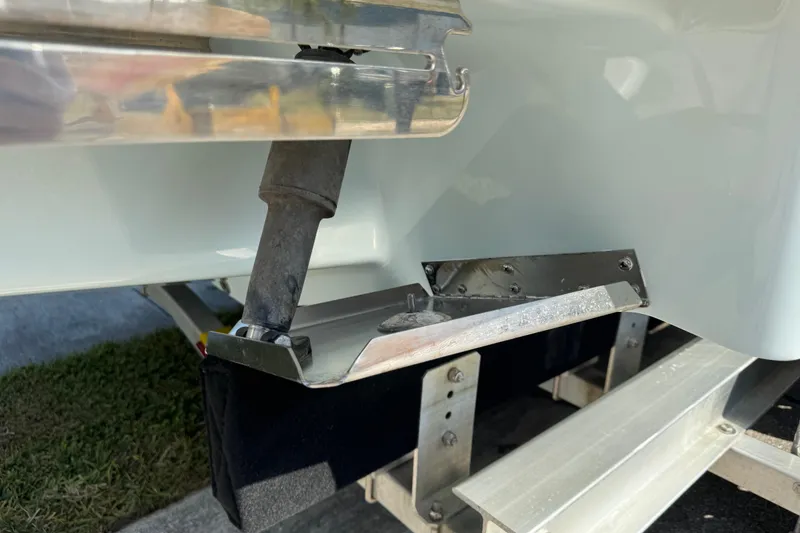 Slide: The Image of 2024 Chaparral 280 OSX boat detail showing hull and trailer components. - 23