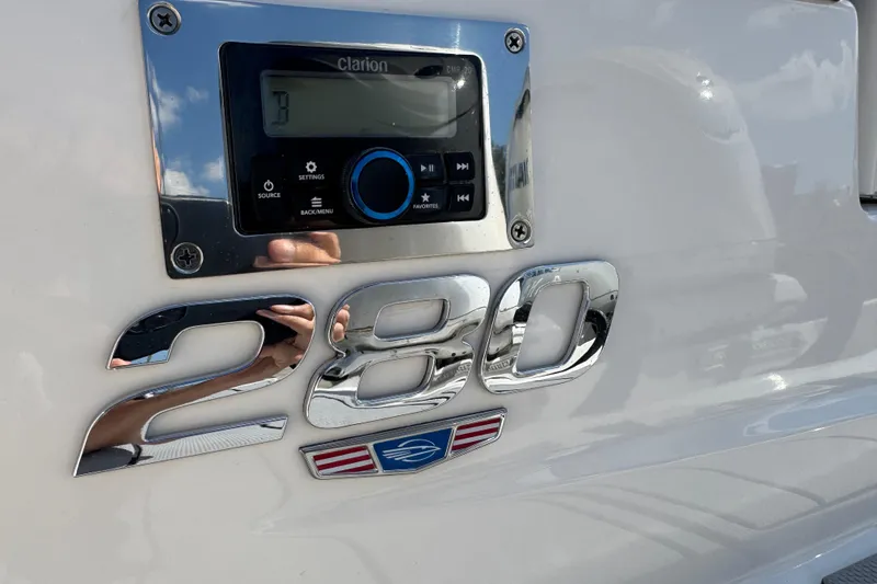 Slide: The Image of 2024 Chaparral 280 OSX boat with Clarion audio system and chrome emblem. - 26