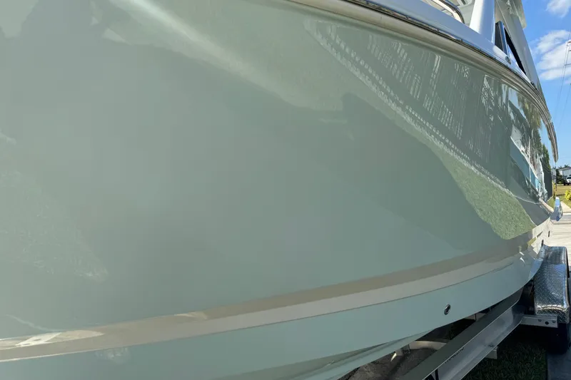 Slide: The Image of 2024 Chaparral 280 OSX boat side view, showcasing sleek design and glossy finish. - 31