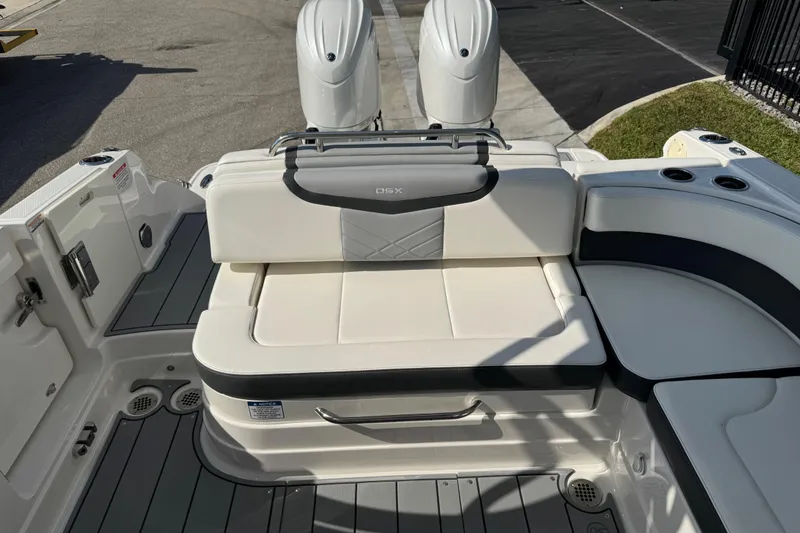 Slide: The Image of 2024 Chaparral 280 OSX boat interior with white seating and dual engines. - 34