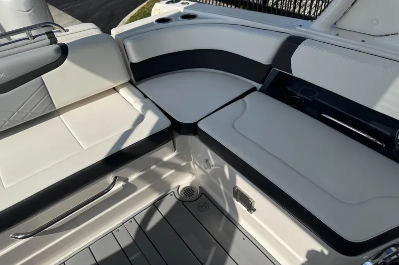Slide: The Image of 2024 Chaparral 280 OSX boat interior seating with sleek white and black design. - 35