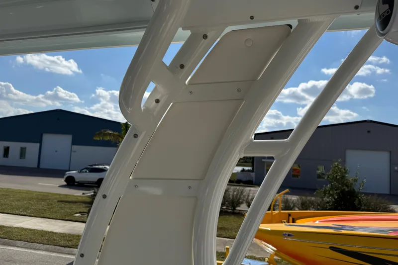 Slide: The Image of 2024 Chaparral 280 OSX boat structure with clear sky and industrial background. - 41
