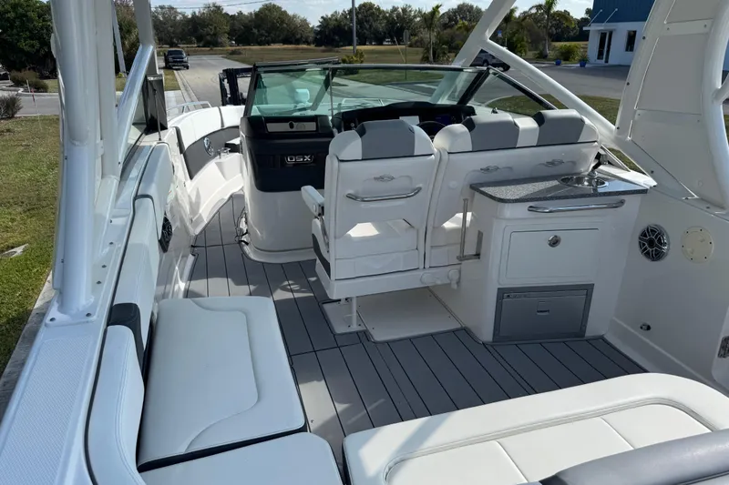 Slide: The Image of 2024 Chaparral 280 OSX boat interior with seating, helm, and kitchenette. - 50