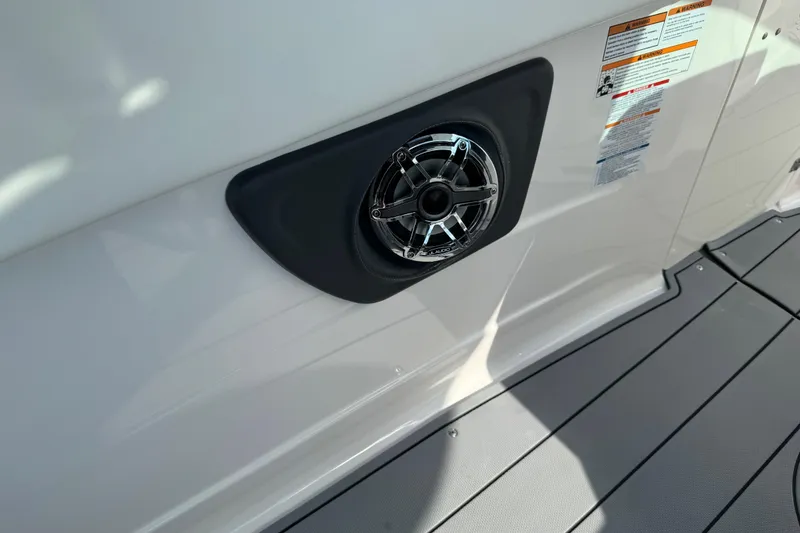 Slide: The Image of 2024 Chaparral 280 OSX boat speaker detail on deck with safety labels. - 53