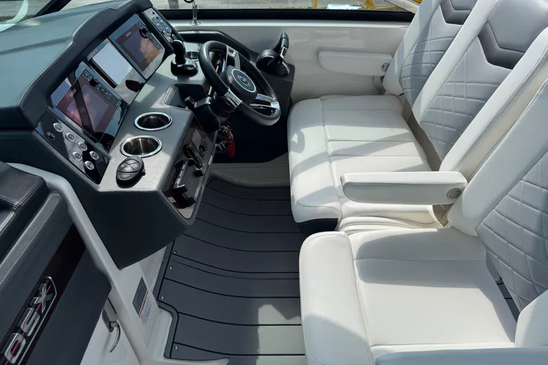 Slide: The Image of 2024 Chaparral 280 OSX boat interior with modern dashboard and luxurious seating. - 55