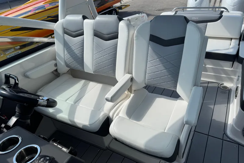 Slide: The Image of 2024 Chaparral 280 OSX boat interior with modern seating and steering wheel. - 56
