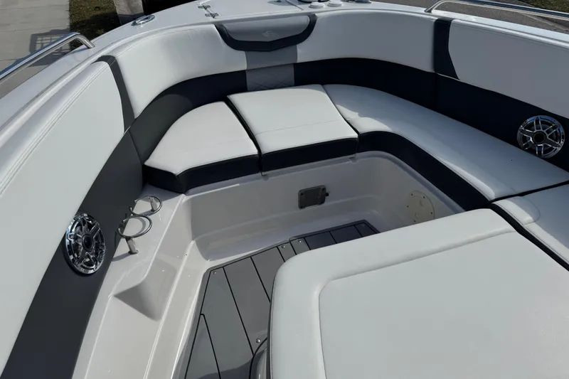 Slide: The Image of 2024 Chaparral 280 OSX boat interior with cushioned seating and cup holders. - 58