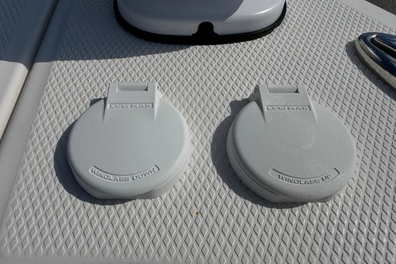 Slide: The Image of 2024 Chaparral 280 OSX boat windlass controls on textured deck surface. - 60