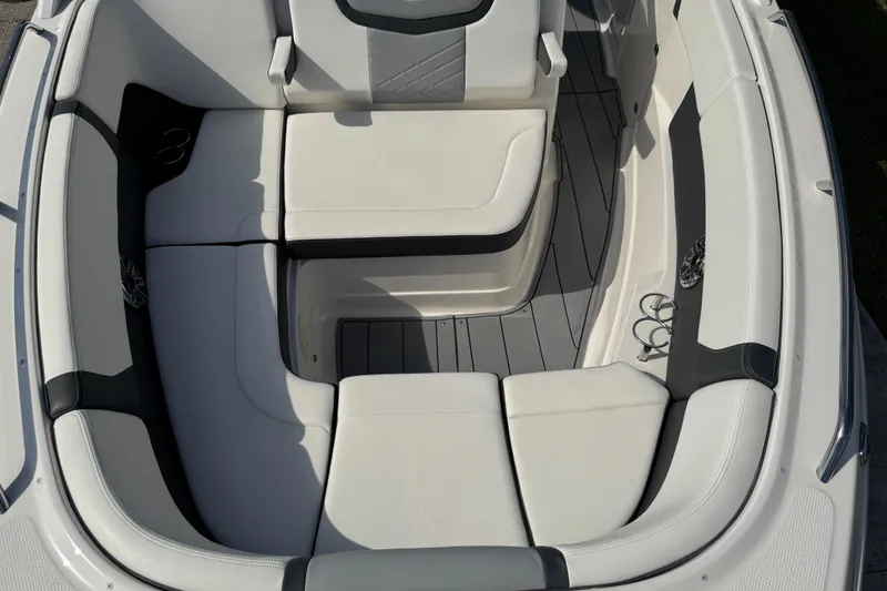 Slide: The Image of 2024 Chaparral 280 OSX boat interior with white seating and cup holders. - 62