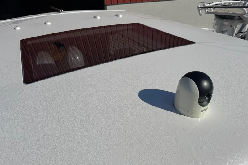 Slide: The Image of Rooftop of 2024 Chaparral 280 OSX boat with a camera and tinted window. - 65