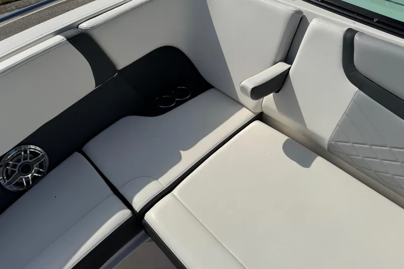 Slide: The Image of 2024 Chaparral 280 OSX boat interior with cushioned seating and speaker. - 69