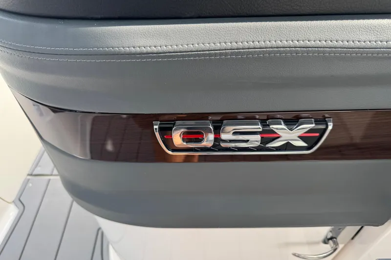 Slide: The Image of 2024 Chaparral 280 OSX boat interior detail with logo and sleek design. - 75