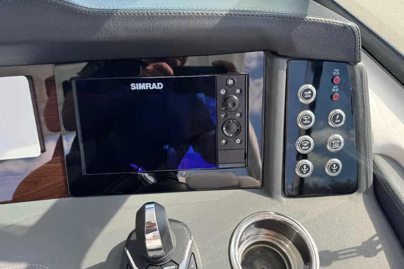 Slide: The Image of 2024 Chaparral 280 OSX dashboard with Simrad display and control panel. - 77