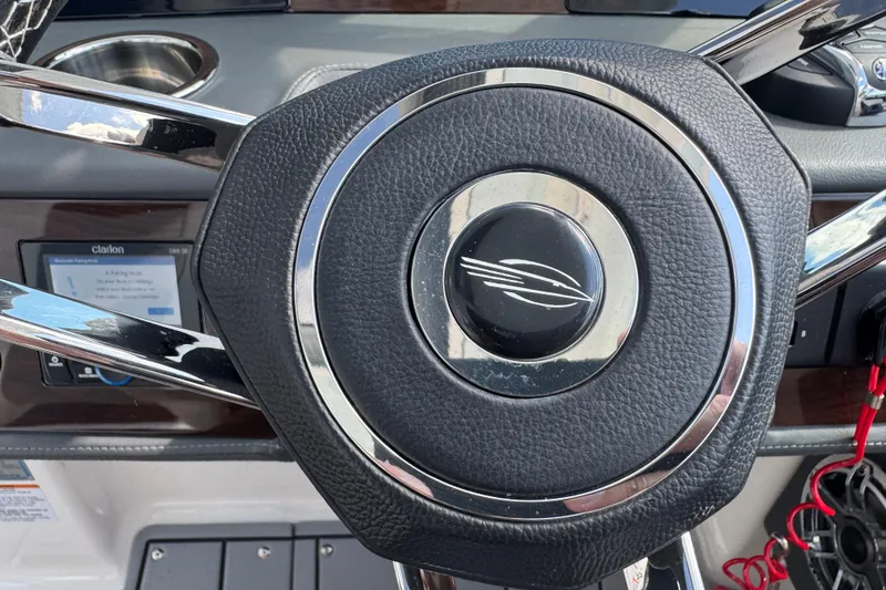 Slide: The Image of Steering wheel of 2024 Chaparral 280 OSX boat, featuring sleek design and modern controls. - 83