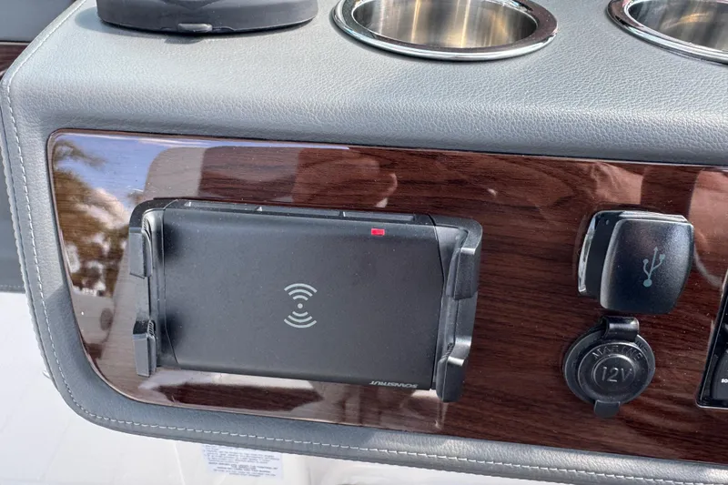 Slide: The Image of 2024 Chaparral 280 OSX dashboard with wireless charging pad and USB port. - 85