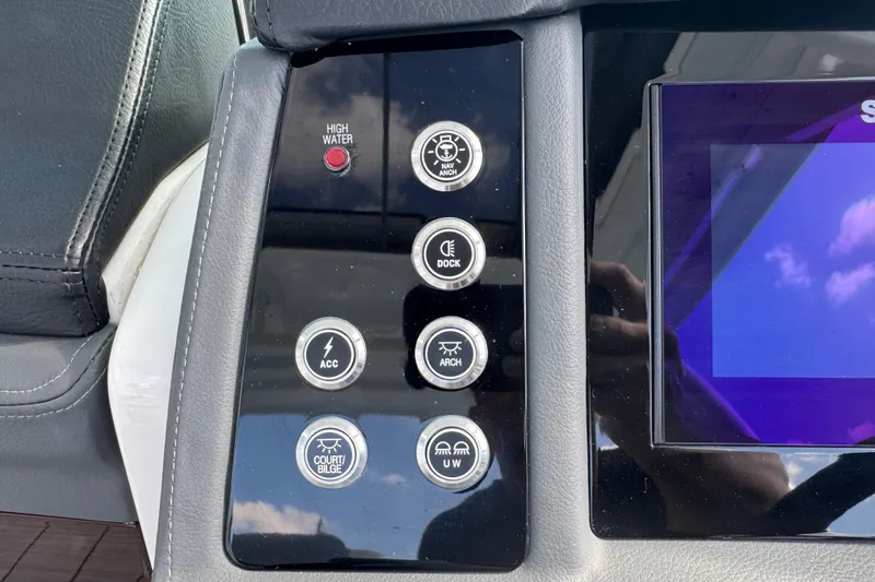 Slide: The Image of Control panel of 2024 Chaparral 280 OSX boat with various function buttons. - 87