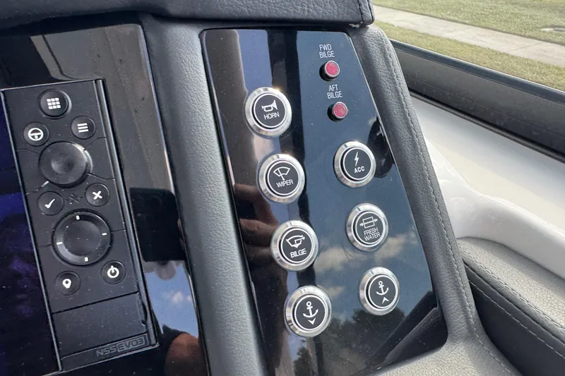 Slide: The Image of Control panel of 2024 Chaparral 280 OSX boat with various function buttons. - 88