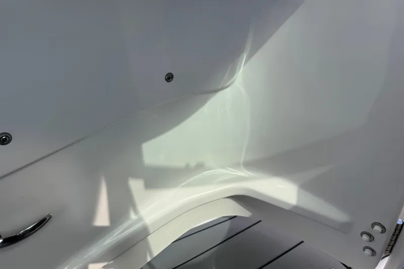 Slide: The Image of Interior detail of 2024 Chaparral 280 OSX boat, showcasing sleek white design. - 92