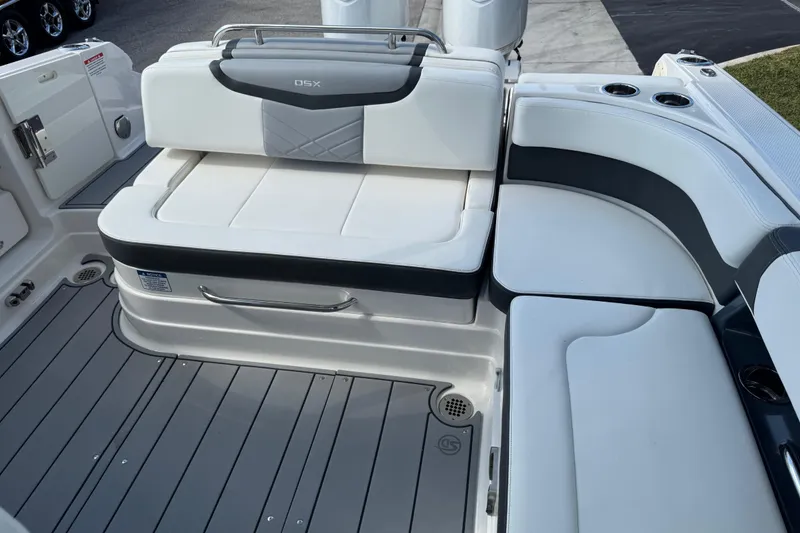 Slide: The Image of 2024 Chaparral 280 OSX boat interior with white cushioned seating and sleek design. - 93