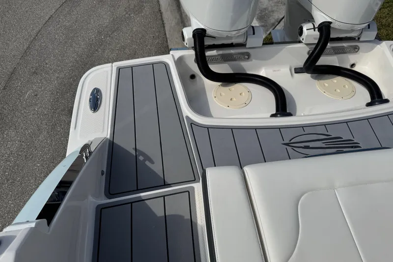 Slide: The Image of 2024 Chaparral 280 OSX boat deck with dual engines and sleek design. - 96