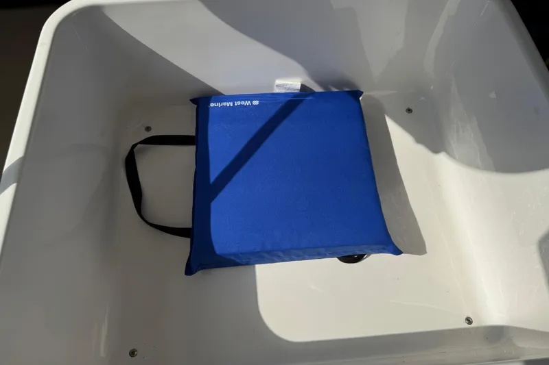 Slide: The Image of Blue cushion in a Chaparral 280 OSX 2024 boat's white compartment. - 99